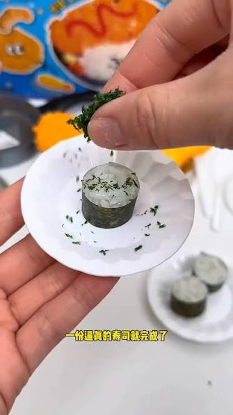Hand holding a tiny clay sushi plate made in a miniature food workshop