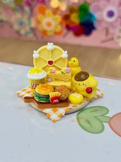 Miniature clay dessert cups and sundaes made in a kids food charm workshop