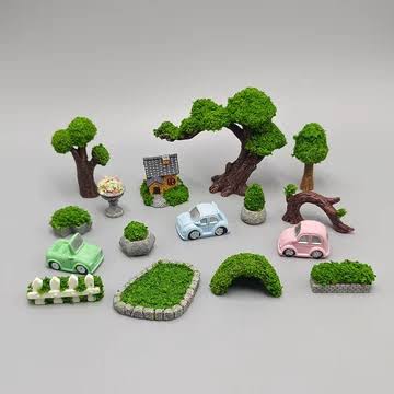 Miniature landscape pieces including tiny trees cars and hedges