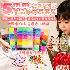 Child working with a large 5mm fuse bead kit at a craft table