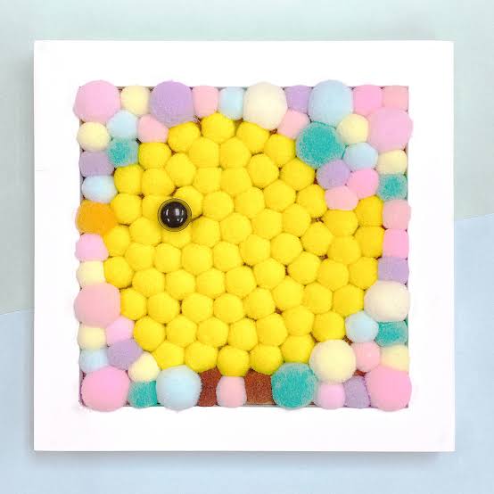 Framed pom-pom art picture of a yellow chick made from fluffy pom-poms