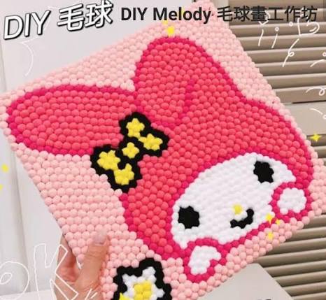Pink pom-pom art picture of a cartoon character in a frame