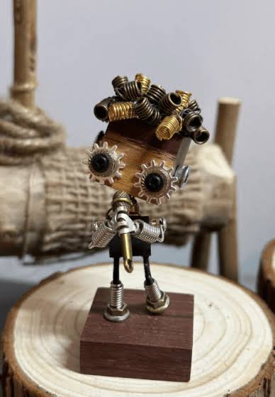 Punk robot sculpture built from bolts gears and metal scrap on a wood base
