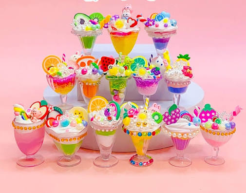 Cream glue dessert cups decorated with fruit charms and sprinkles