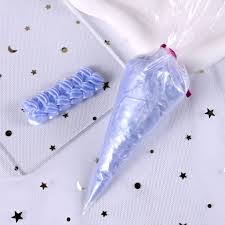 Piping bag filled with blue whipped cream glue ready for decorating